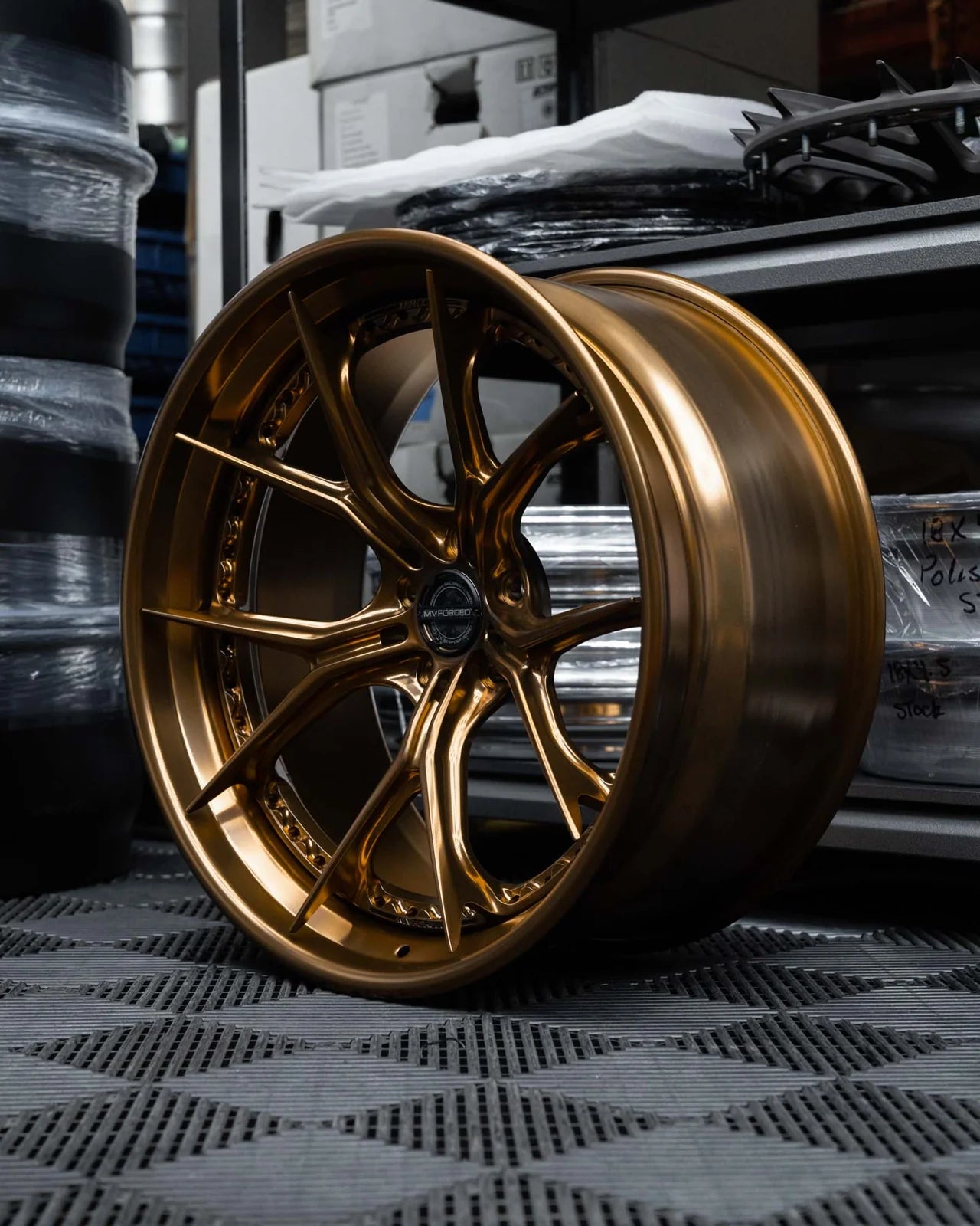 MV Forged SL-102 Spoke-Lite forged wheel, 3-piece in a gold finish on a display shelf