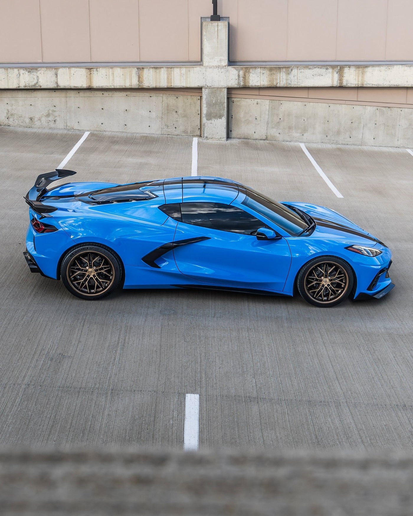 Rohana RFC3 Machine Bronze on a Blue C8 Corvette